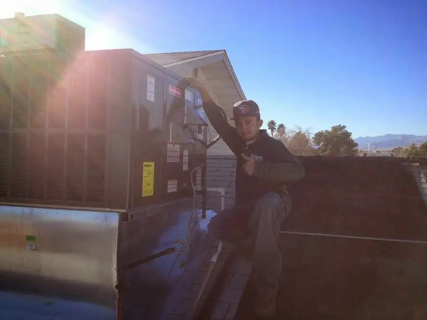HVAC technician performing AC Tune-Up on a rooftop unit in Straban